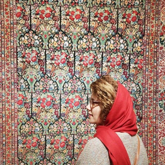 Image of a Carpet feauturing vases filled with roses